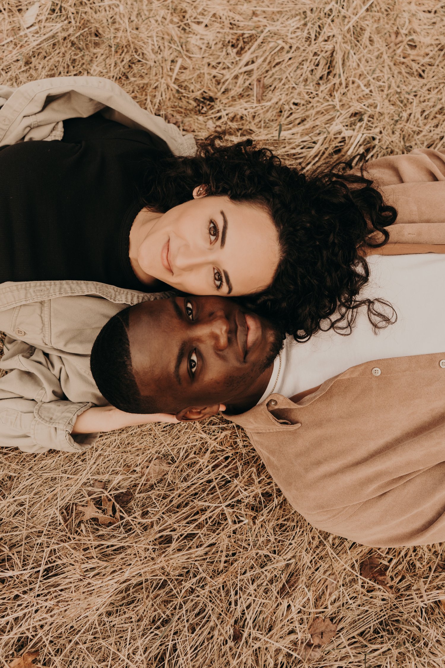 Couple lying together in golden grass