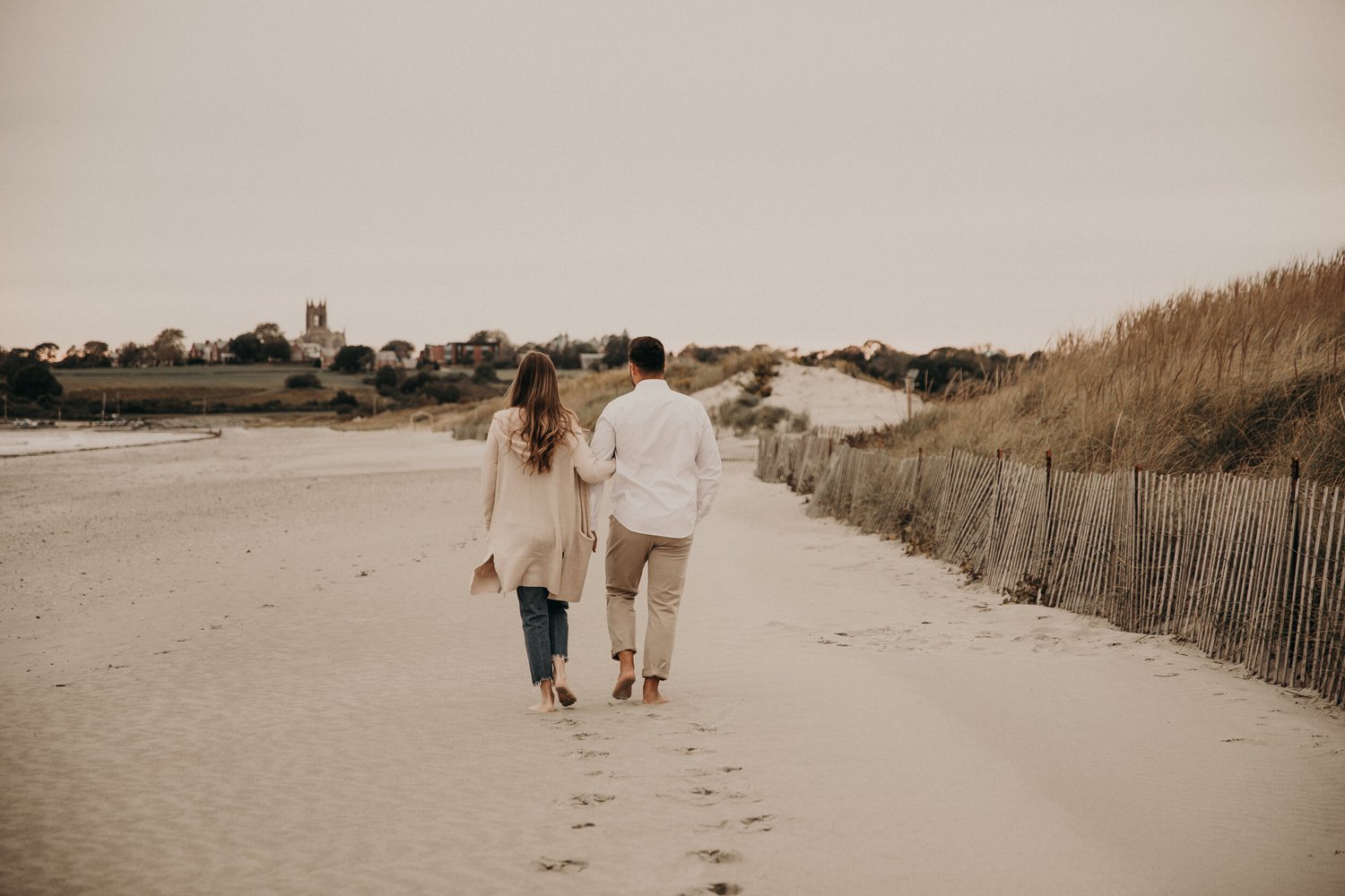 Couple walking barefoot on Second Beach, Middletown RI